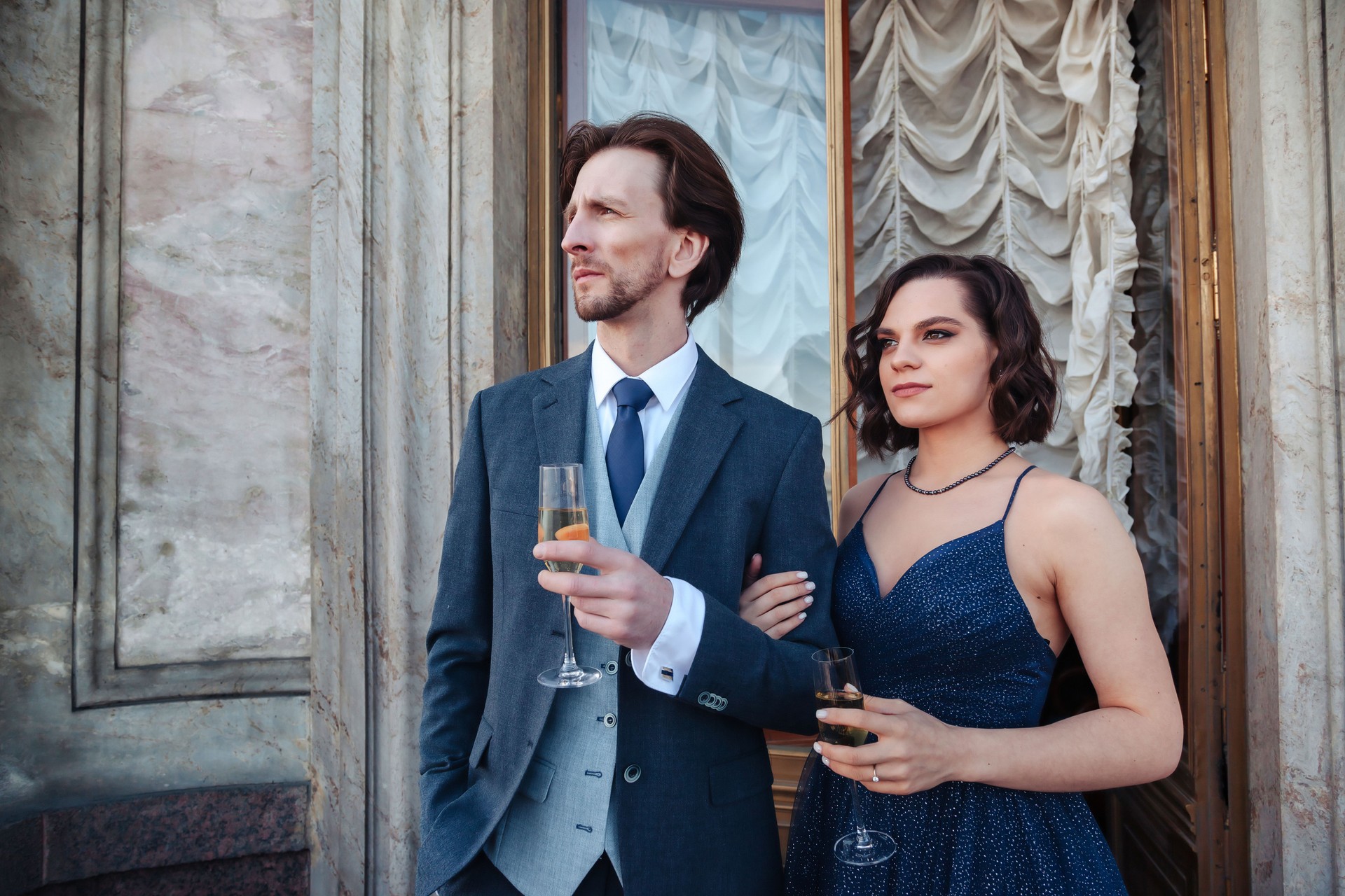 Couple, man and woman, with champagne on balcony