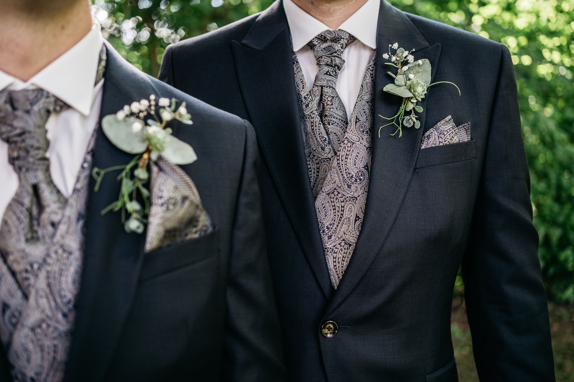 body part of gay couple with suits and bow tie